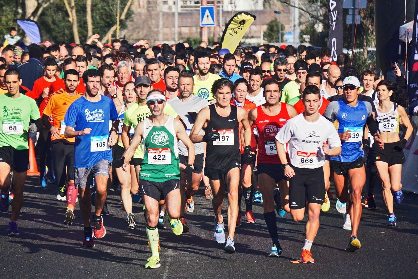 A dense pack of runners at the start of a road race